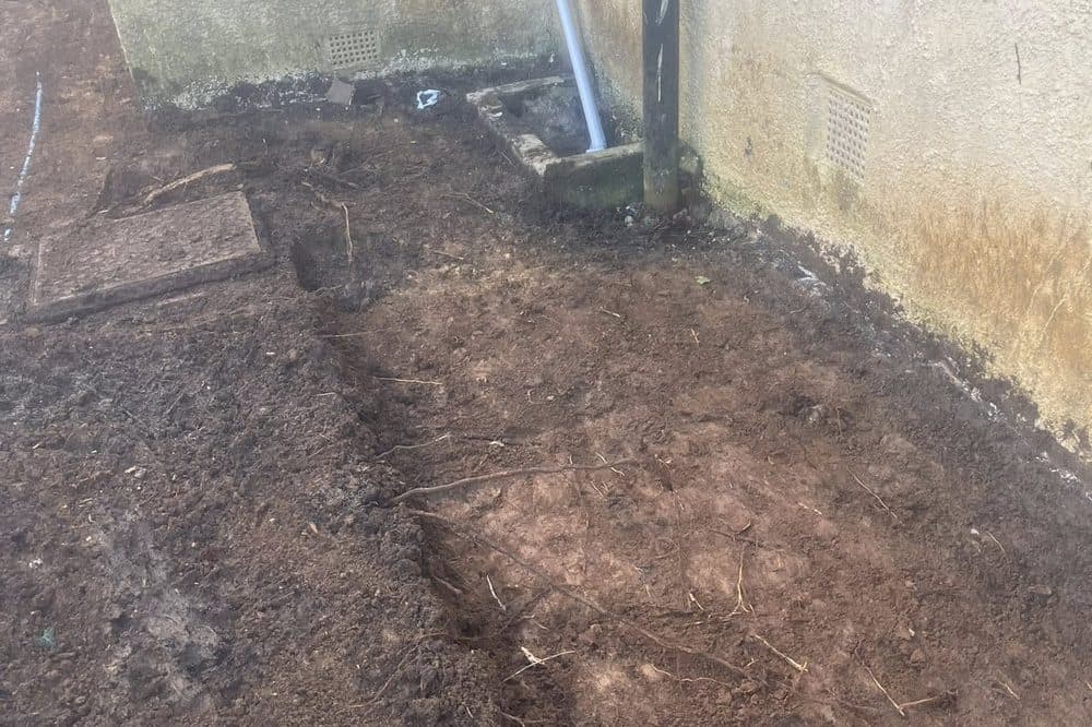 Before: side-path area excavated to expose drainage and soil