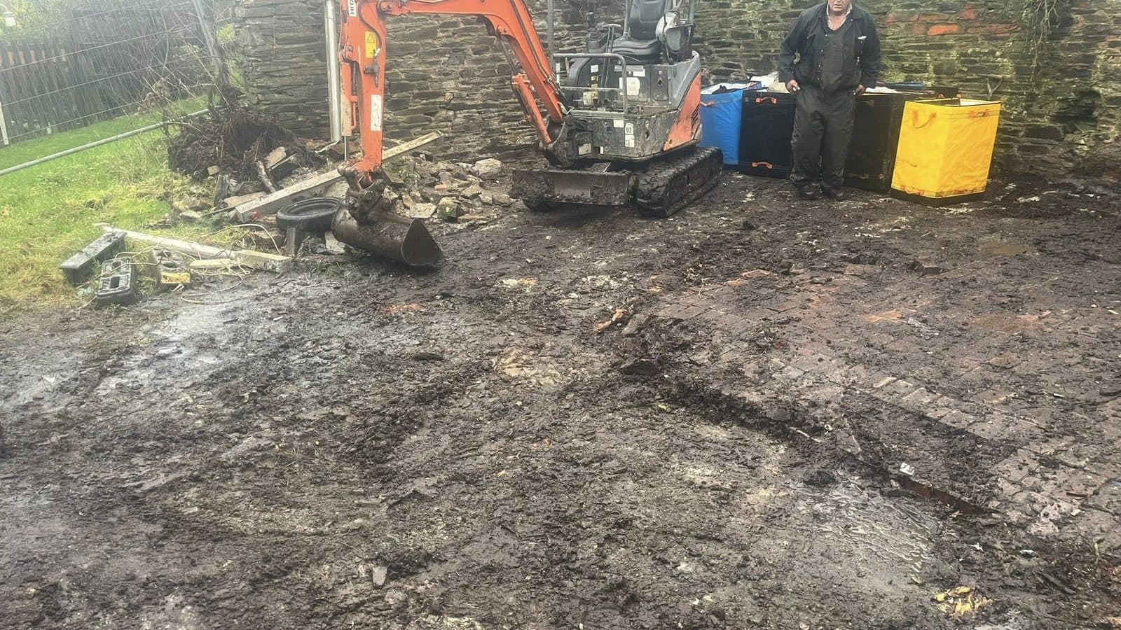 GLR Waste Removals on site in Launceston — owner stood next to the Kubota mini-digger after a stone-wall clearance job